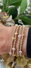 Pink pearls and cross bracelet