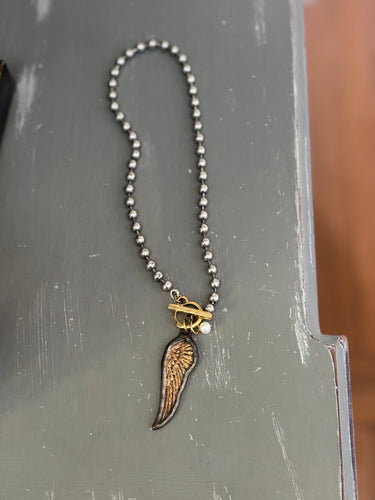Wing and pearl necklace
