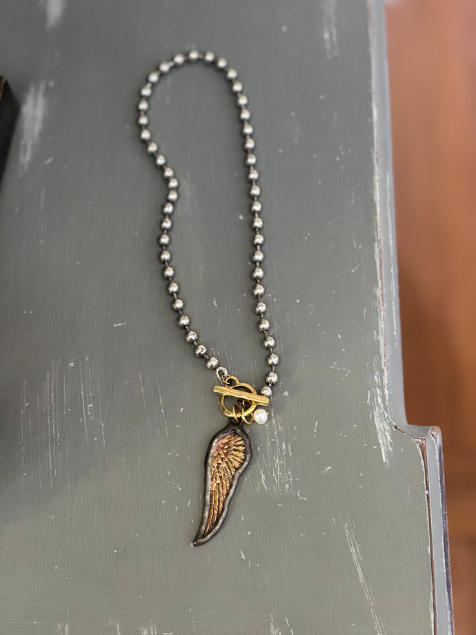 Wing and pearl necklace